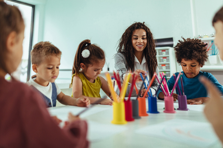 children with their teacher painting