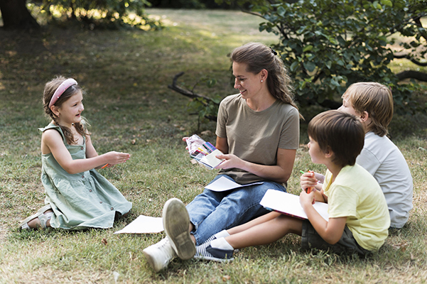 Small group learning outdoors with teacher support