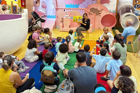 Children participating in group storytelling activity supporting early reading preschool Pembroke Pines